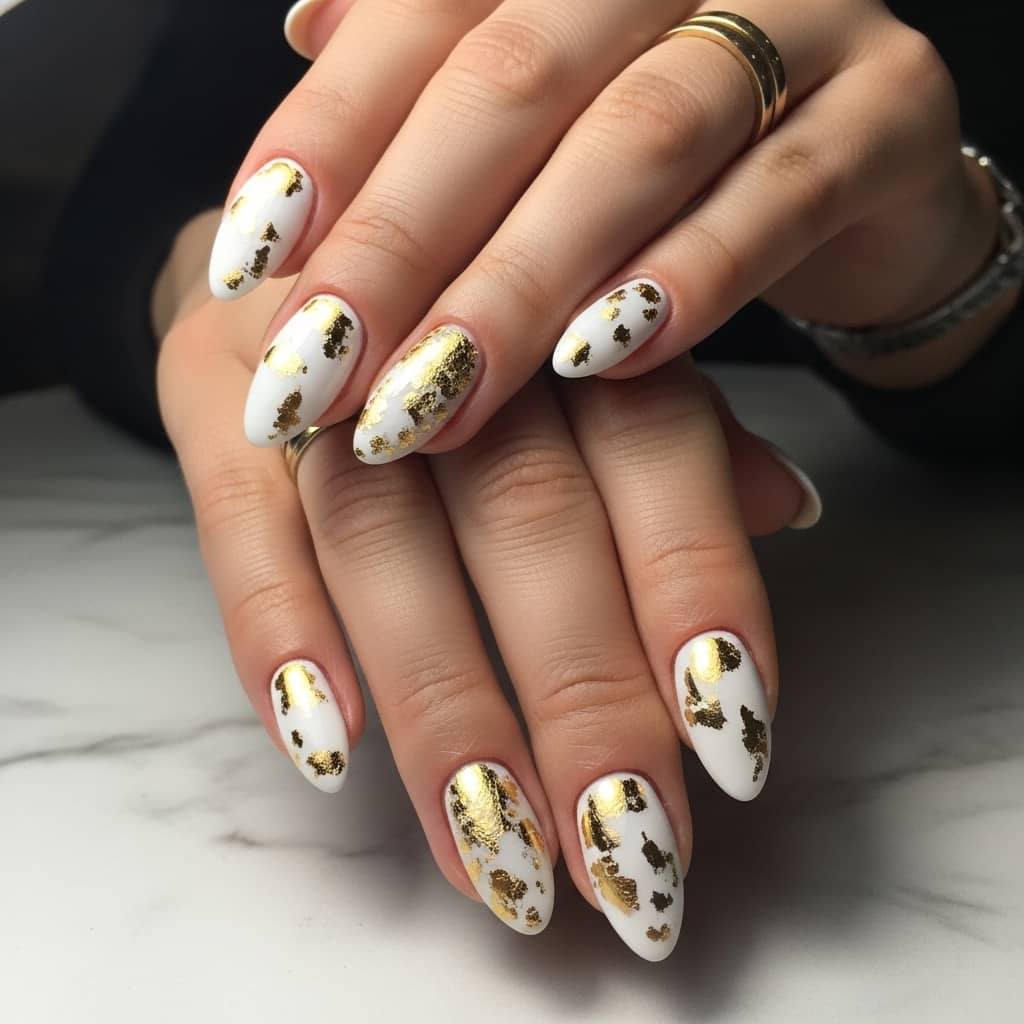 nail art design with white base and gold foil accents